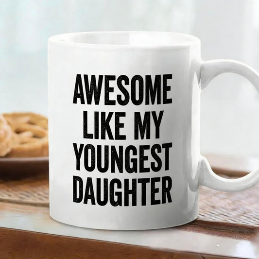 The Mug, Printed With The Phrase "AWESOME LIKE MY YOUNGEST DAUGHTER," Is A Gift Mug For Mothers And Fathers.